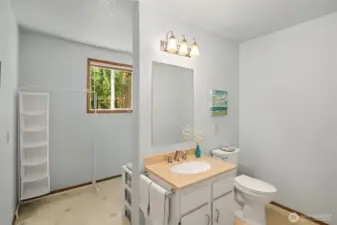 Large utility room with half bath.