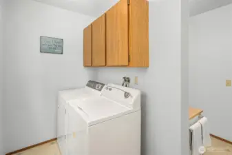 Full size washer and dryer with cabinet storage.