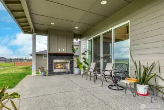 Covered patio with outdoor fireplace, with access to great room and kitchen.