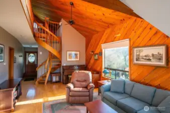 Main house living area, bent spruce spiral staircase to the upper level and the front entryway