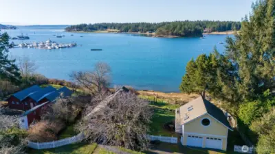 Aerial looking west out toward the spit and peninsula (Lopez Island). Islands Marine Center and Islander docks seen in upper left