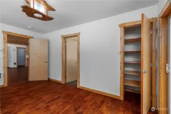 Primary Bedroom with Custom trim, Closet, Oak Flooring.