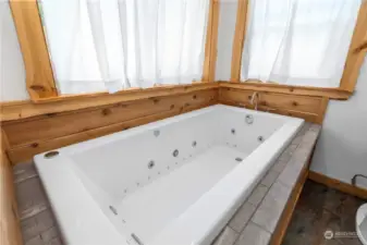 Jacuzzi Bathtub with Tile edging.