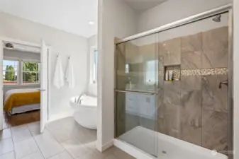 Separate tub and shower in primary suite bath.