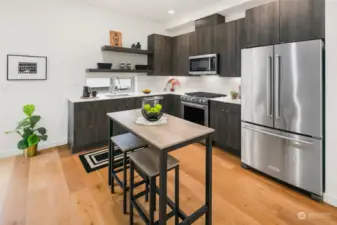 Bright kitchen with abundance of cabinets and quartz countertops.