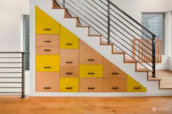 Custom designed drawers built in under stairs for utilizing space.