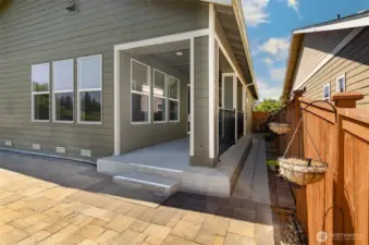 Porch leads to extended paved patio.