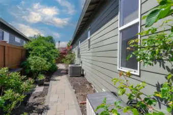 The side yard has many lovely plantings.  The lot size is larger than most.