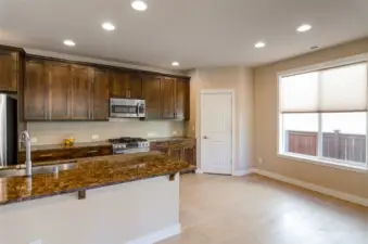 Another vie of the kitchen showing corner pantry and  breakfast nook.