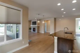 View from the nook.  Engineered hardwood floors through main living areas.  Beautiful quartz counter tops.  Great room ahead.