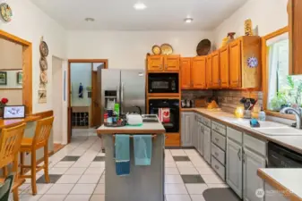 ANOTHER VIEW OF THE KITCHEN SHOWING THE ISLAND & BREAKFAST BAR