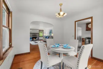 Original touches continue through the dining room with original light fixture and fir floors.