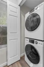 Laundry is hidden behind this door in the kitchen