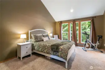 The upstairs primary ensuite features vaulted ceilings, enhancing the sense of space and openness.