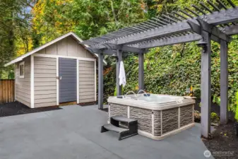 Hot tub and shed in backyard.