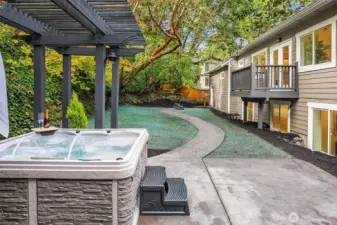 hydroseed on will sprout in 3-5 weeks. Hot tub showing fully fenced backyard and private balcony off main floor primary.