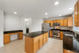 Granite countertops throughout kitchen.