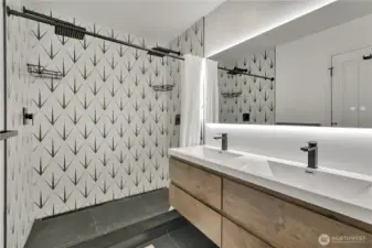 Remodeled primary bath with modern finishes.