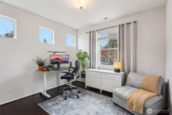Main level bedroom that is currently being utilized as a functional and dedicated home office space.