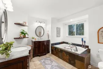 Oversized soaking tub overlooking the backyard garden