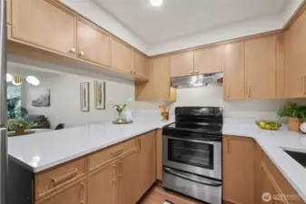 Kitchen with new cabinetry, quartz countertops and lighting