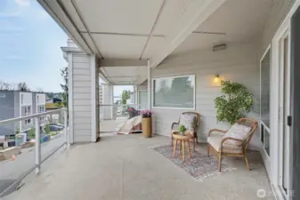 South-facing covered deck off of living area with Lake Washington view