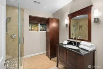 A ¾ bath located near the downstairs bedroom creates the perfect setup for an ideal guest suite, offering comfort, privacy, and convenience for visitors or multi-generational living.