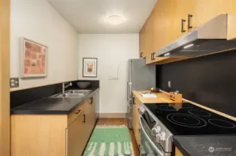 Contemporary kitchen with stainless steel appliances and ample cabinetry.