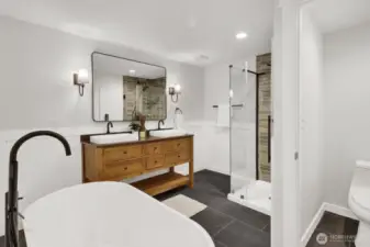 The primary bath is a spa retreat with high-end tile, walk-in shower, soaker tub, private toilet, and lots of space