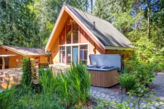 Newer metal roof on the main home and a new composition roof on the "shop" along with a glorious hot tub, garden and more...