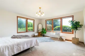 expansive primary bedroom with numerous windows