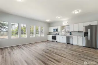 looking from the door into the room with a full kitchen.
