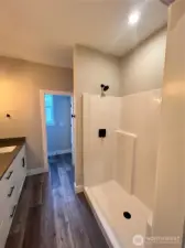 Step in shower in primary suites. Buyer can upgrade to tile showers. *previous build