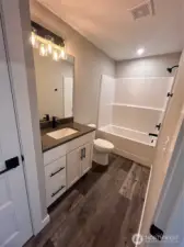 Full guest bath with tub/shower combo and linen closet. Please note cabinet, countertops and flooring selection follow through the whole house. *previous build