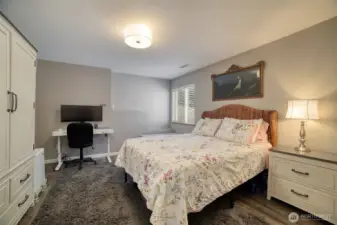 Generously sized downstairs bedroom offers abundant space for a full bedroom setup with room to spare for a desk, seating area, or additional storage