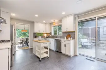 Bright white cabinetry and a stylish tiled backsplash create a timeless, inviting setting for this well-appointed kitchen.