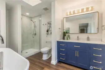 Expanded primary bathroom includes skylight and modern touches