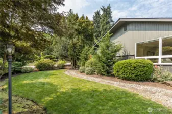 Front yard is bordered by mature trees, providing a natural screen