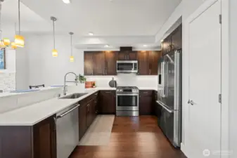 Chef's kitchen with high-end Bosch appliances, quartz counters, and soft close cabinetry.