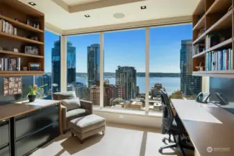 Attention to details in this home office with customized shelving and space for office equipment.