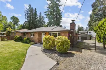 Warm inviting front of home with a deep driveway for RV parking