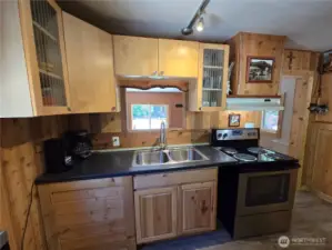The kitchen has a nice view of the front yard through the entry room.