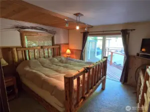 The primary bedroom easily accommodates this huge king sized bed.