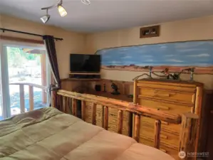 Stampeding wild horses mural on the wall of the primary bedroom.