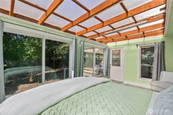 Sunroom with door to backyard