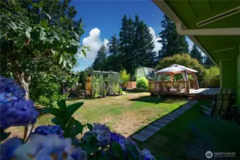 Huge, fully fenced, level backyard with 20' x 16' deck & gazebo, garden areas, shed/chicken/coop.