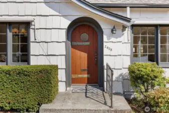 Custom built solid wood front door with vintage hardware.