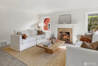 Living room with custom wood mantel and coved ceilings and lead glass windows