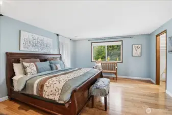 Spacious primary suite with peaceful outlooks, generous layout, and bonus storage tucked behind the bed wall.