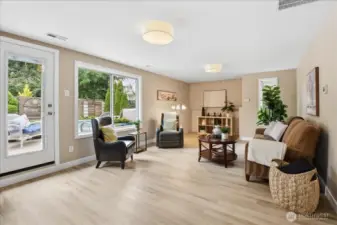 Spacious lower-level family room with patio access and easy connection to the hot tub and in-ground pool.